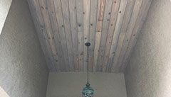 Rustic Barnwood Sandstone installed on range hood in kitchen. Reclaimed barn wood look